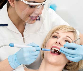 Doctor treats patient teeth in dental clinic